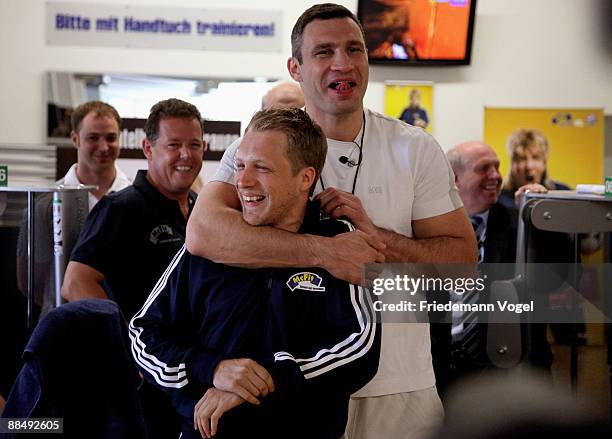 Vitali Klitschko and Oliver Pocher laugh during the presentation of the competency team for Oliver Pochers casting show at the Mc Fit studio on June...