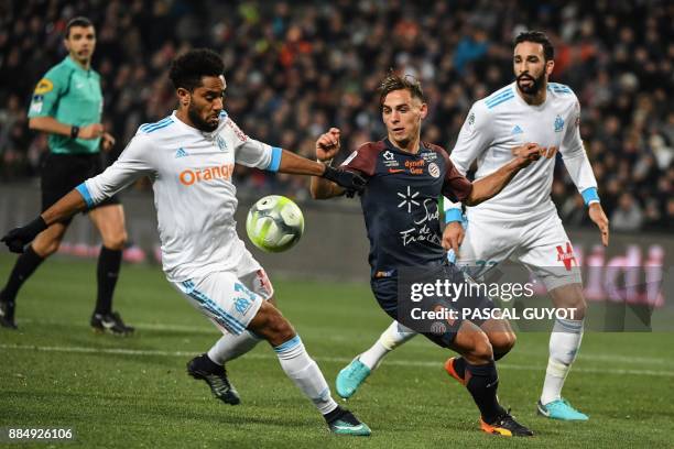 Montpellier's French defender Ruben Aguilar vies with Marseille's French defender Jordan Amavi and Marseille's French defender Adil Rami during the...