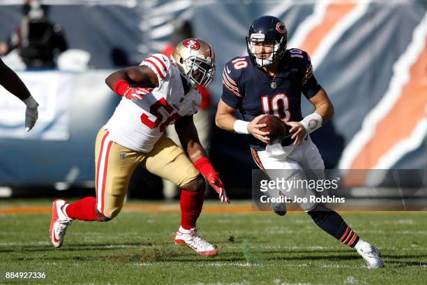 Quarterback Mitchell Trubisky of the Chicago Bears carries the football past Elvis Dumervil of the San Francisco 49ers in the second quarter at...