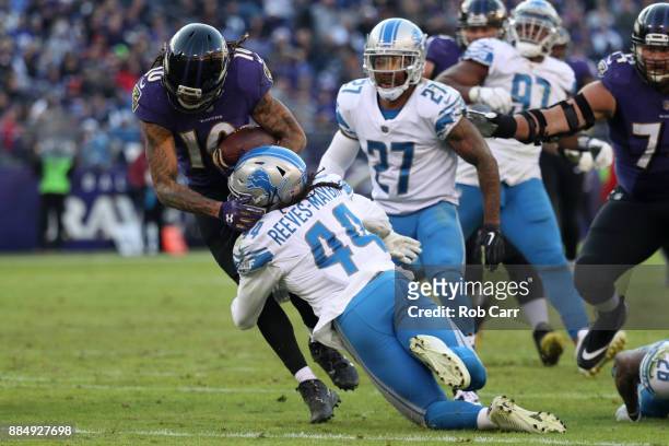 Wide Receiver Chris Moore of the Baltimore Ravens is tackled by linebacker Jalen Reeves-Maybin of the Detroit Lions in the fourth quarter at M&T Bank...
