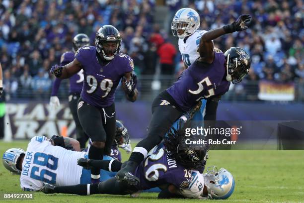Wide receiver Golden Tate of the Detroit Lions is tackled by cornerback Maurice Canady and inside linebacker C.J. Mosley of the Baltimore Ravens in...