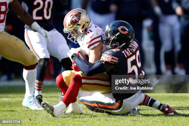 Danny Trevathan of the Chicago Bears tackles Trent Taylor of the San Francisco 49ers in the second quarter at Soldier Field on December 3, 2017 in...