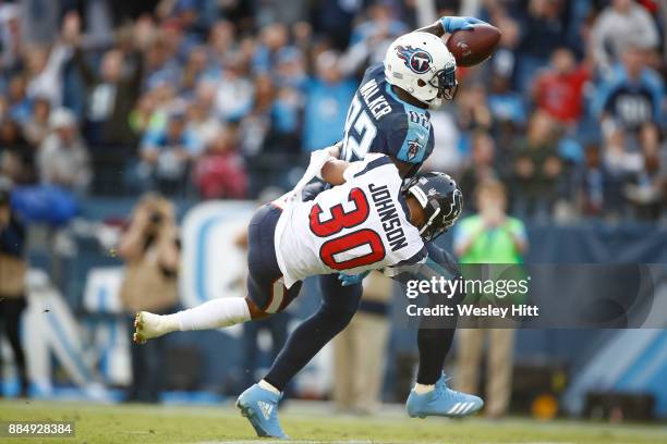 Delanie Walker of the Tennessee Titans runs into the endzone for a touchdown defended by Kevin Johnson of the Houston Texans during the second half...