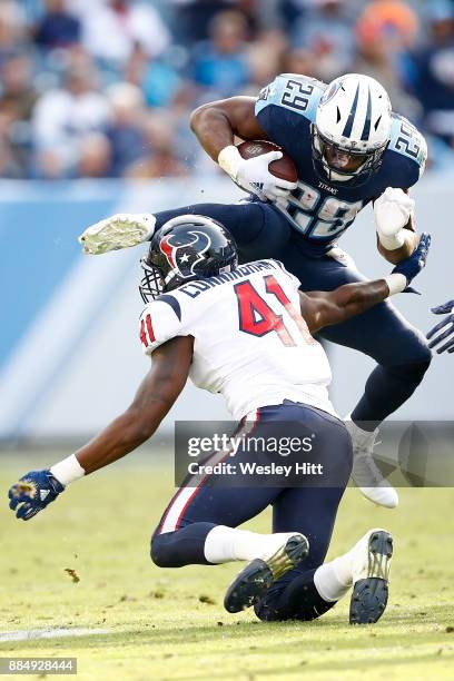 DeMarco Murray of the Tennessee Titans leaps over Zach Cunningham of the Houston Texans during the second half at Nissan Stadium on December 3, 2017...