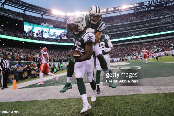 Elijah McGuire of the New York Jets celebrates with Jermaine Kearse of the New York Jets after scoring a touchdown in the fourth quarter during their...