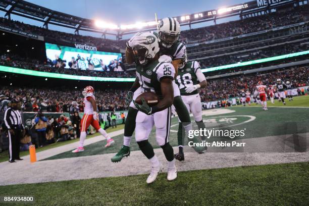 Elijah McGuire of the New York Jets celebrates with Jermaine Kearse of the New York Jets after scoring a touchdown in the fourth quarter during their...
