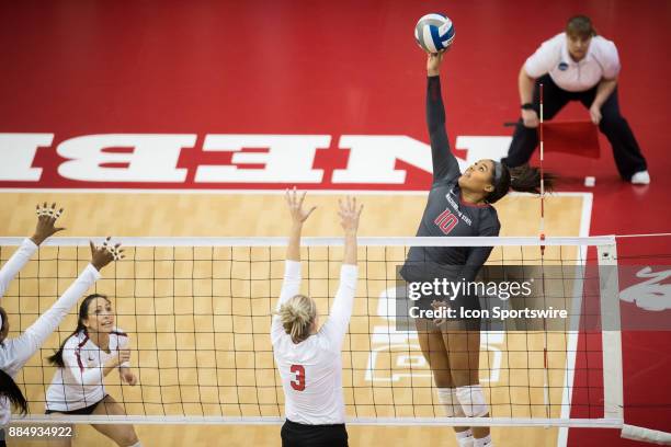 Washington State outside hitter Taylor Mims hits the ball over Nebraska setter Kelly Hunter in the first set Saturday, December 2nd at the Devaney...