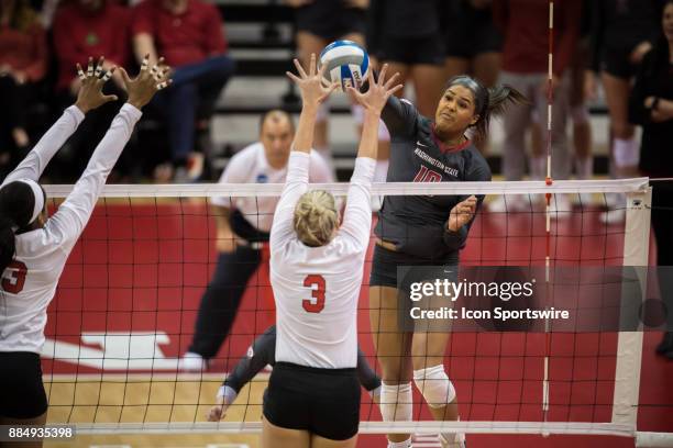 Washington State outside hitter Taylor Mims spikes the ball against Nebraska setter Kelly Hunter in the second set Saturday, December 2nd at the...