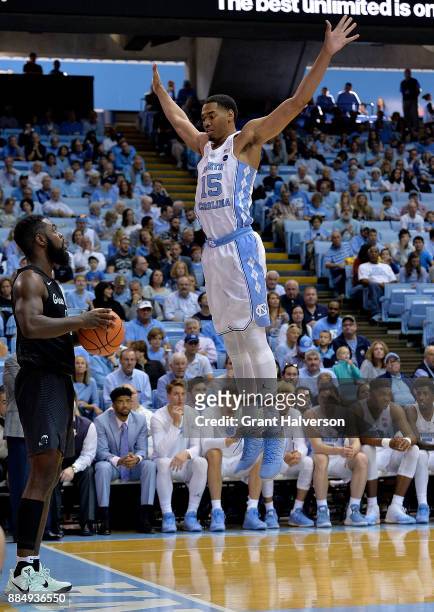 Garrison Brooks of the North Carolina Tar Heels defends an inbounds pass by Jordan Cornish of the Tulane Green Waveduring their game at the Dean...