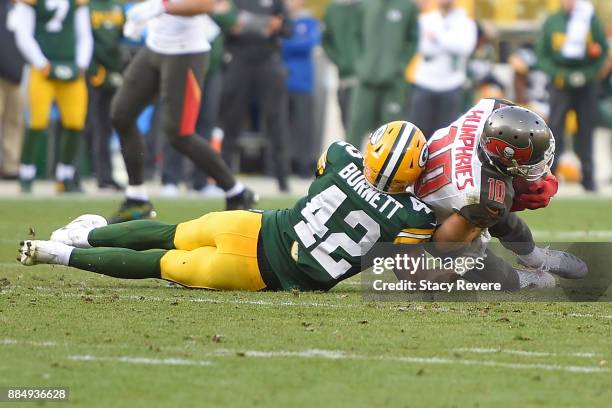 Adam Humphries of the Tampa Bay Buccaneers is brought down by Morgan Burnett of the Green Bay Packers during the second half at Lambeau Field on...
