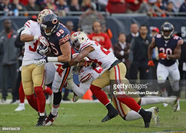 Daniel Brown of the Chicago Bears is tackled by Eric Reid, K'Waun Williams and Reuben Foster of the San Francisco 49ers at Soldier Field on December...