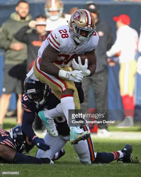 Carlos Hyde of the San Francisco 49ers is tackeld by Prince Amukamara of the Chicago Bears at Soldier Field on December 3, 2017 in Chicago, Illinois....