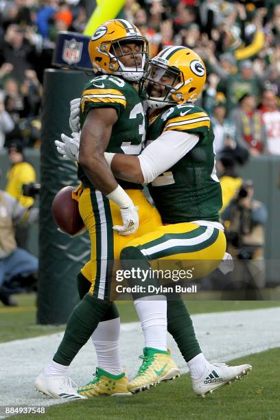 Aaron Jones of the Green Bay Packers celebrates with Richard Rodgers after scoring a touchdown to beat the Tampa Bay Buccaneers 26-20 in overtime at...