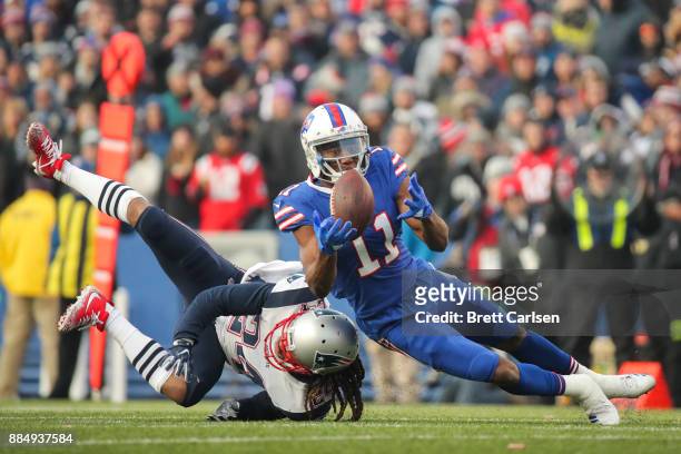 Zay Jones of the Buffalo Bills attempts to catch the ball as Stephon Gilmore of the New England Patriots attempts to defend him during the fourth...
