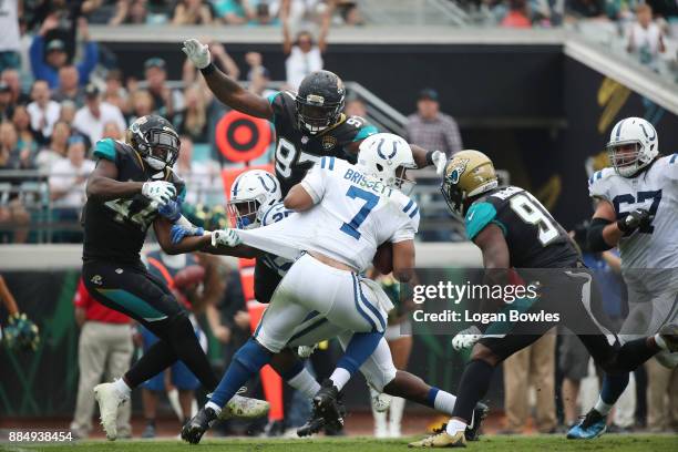 Jacoby Brissett of the Indianapolis Colts is pressured by a group of Jacksonville Jaguars defenders in the second half of their game at EverBank...