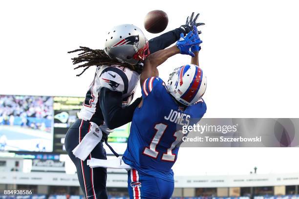 Stephon Gilmore of the New England Patriots attempts to break up a pass to Zay Jones of the Buffalo Bills during the fourth quarter on December 3,...