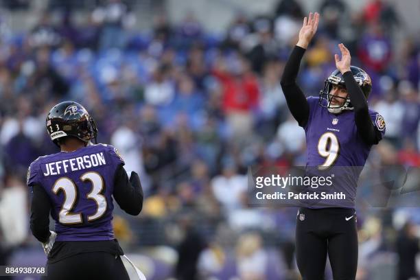 Kicker Justin Tucker and strong safety Tony Jefferson of the Baltimore Ravens celebrate after a field goal in the fourth quarter against the Detroit...