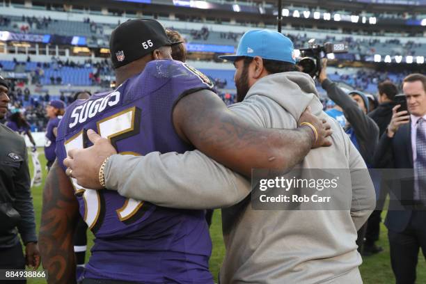 Outside Linebacker Terrell Suggs of the Baltimore Ravens and defensive tackle Haloti Ngata of the Detroit Lions hug after the Ravens 44-20 win over...