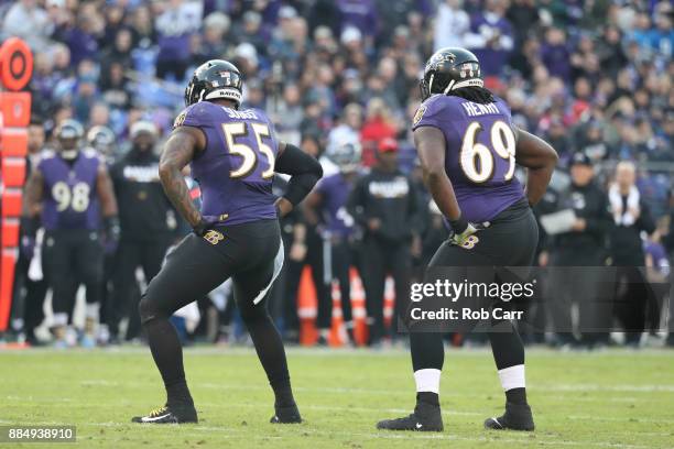 Outside Linebacker Terrell Suggs and defensive tackle Willie Henry of the Baltimore Ravens celebrate after a sack in the fourth quarter against the...