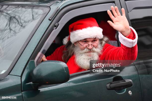 People dressed in Santa Claus costumes are seen during the 17th World Santa Clauses Summit parade held in Western Estonia county capital city Rakvere...