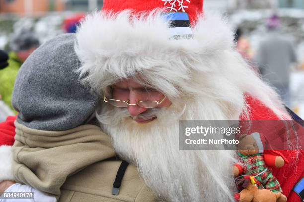 People dressed in Santa Claus costumes are seen during the 17th World Santa Clauses Summit parade held in Western Estonia county capital city Rakvere...