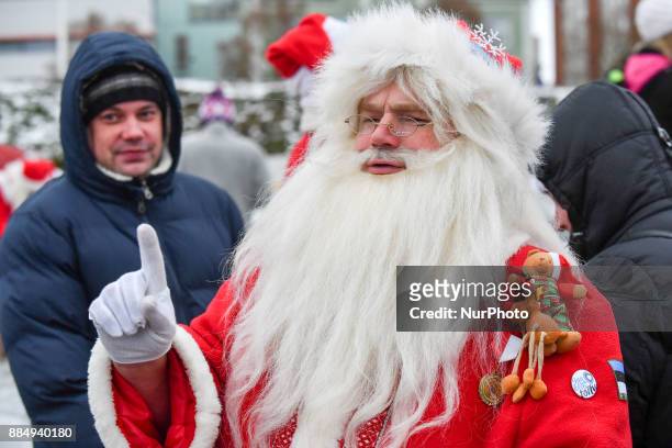 People dressed in Santa Claus costumes are seen during the 17th World Santa Clauses Summit parade held in Western Estonia county capital city Rakvere...