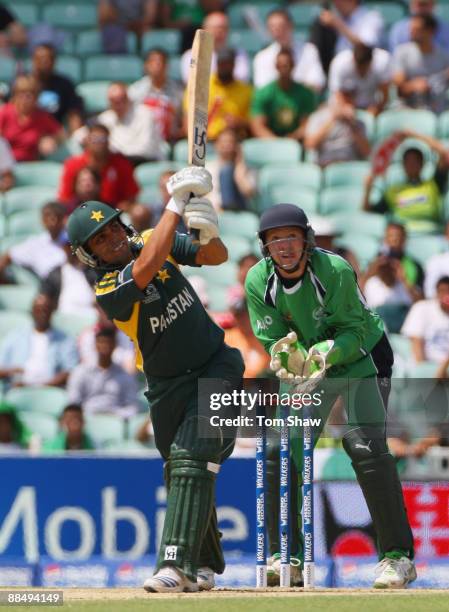 Kamran Akmal of Pakistan hits out watched by Niall O'Brien of Ireland during the ICC World Twenty20 Super Eights match between Ireland and Pakistan...