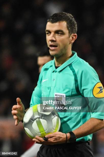 French referee Frank Schneider holds the ball during the French L1 football match between Montpellier and Marseille on December 3, 2017 at the Mosson...