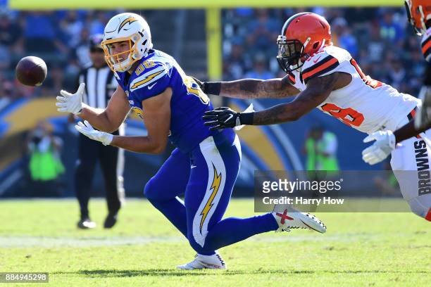 Hunter Henry of the Los Angeles Chargers makes the catch in front of Christian Kirksey of the Cleveland Browns for a first down during the first...