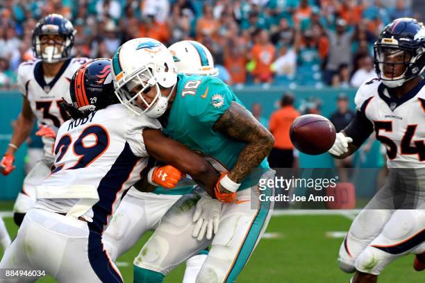 Free safety Bradley Roby of the Denver Broncos knocks the ball loose from wide receiver Kenny Stills of the Miami Dolphins in the 3rd quarter that...