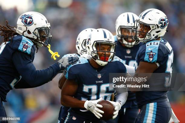 LeShaun Sims of the Tennessee Titans celebrates with teammates after a interception in the closing minute against the Houston Texans during the...