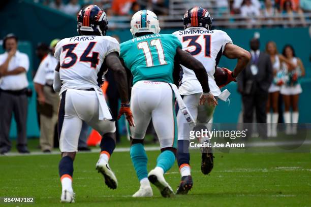 Strong safety Justin Simmons of the Denver Broncos intercepts a ball for a touchdown late in the 3rd quarter to make the score 19-9 the Miami...