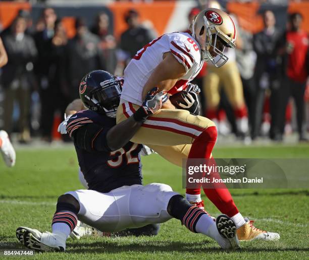 Christian Jones of the Chicago Bears tackles Garrett Celek of the San Francisco 49ers at Soldier Field on December 3, 2017 in Chicago, Illinois. The...