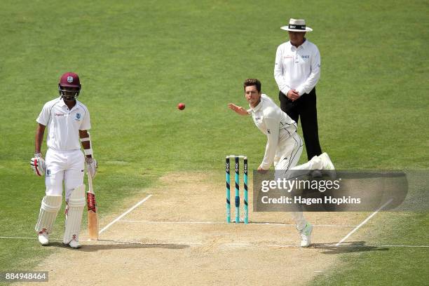 Mitchell Santner of New Zealand bowls while umpire Ian Gould of England and Kraigg Brathwaite of the West Indies look on during day four of the Test...