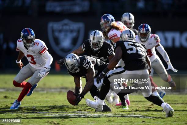 NaVorro Bowman of the Oakland Raiders recovers a fumble by Geno Smith of the New York Giants during their NFL game at Oakland-Alameda County Coliseum...