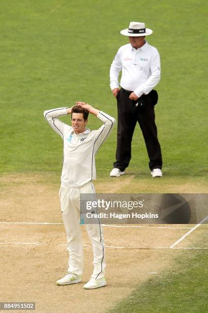 Mitchell Santner of New Zealand looks on after bwling a delivery during day four of the Test match series between New Zealand Blackcaps and the West...