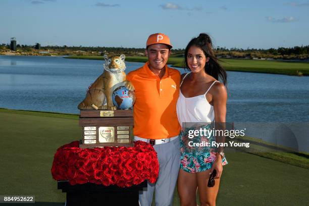 Rickie Fowler and his girlfriend Allison Stokke poses with the trophy during the final round of the Hero World Challenge at Albany course on December...