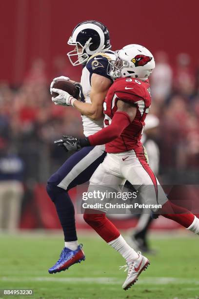 Wide receiver Cooper Kupp of the Los Angeles Rams makes a catch over safety Budda Baker of the Arizona Cardinals during the first half of the NFL...