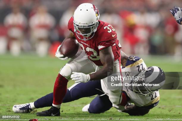 Cornerback Trumaine Johnson of the Los Angeles Rams tackles running back Kerwynn Williams of the Arizona Cardinals during the first half of the NFL...