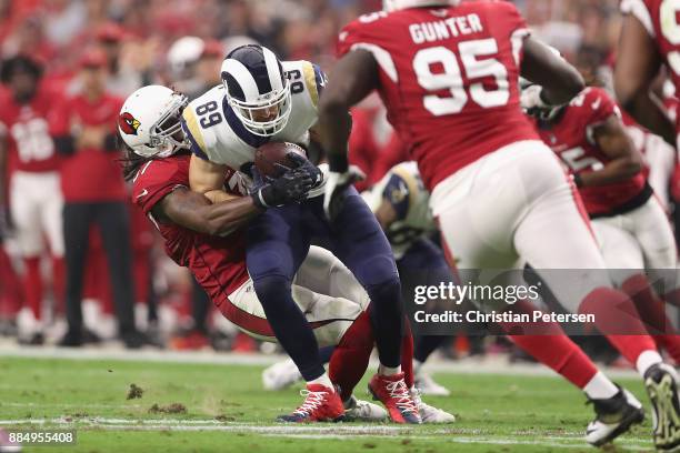 Linebacker Josh Bynes of the Arizona Cardinals tackles tight end Tyler Higbee of the Los Angeles Rams during the first half of the NFL game at the...