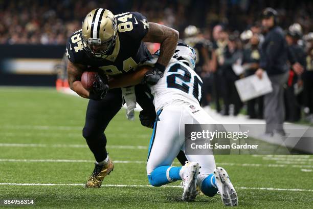 Michael Hoomanawanui of the New Orleans Saints is tackled by Kurt Coleman of the Carolina Panthers during the first half of a NFL game at the...