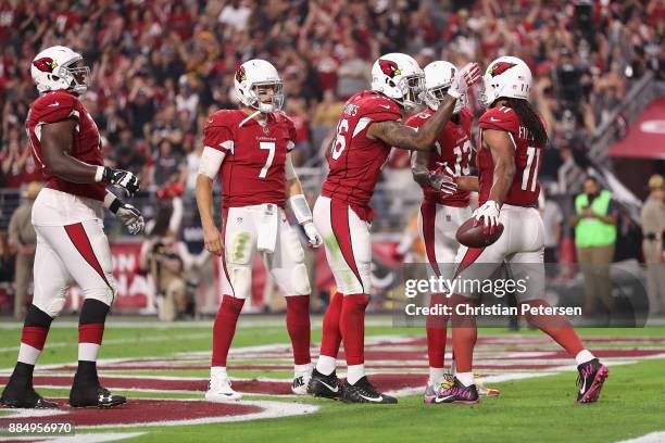 Wide receiver Larry Fitzgerald of the Arizona Cardinals reacts with teammates wide receiver Jaron Brown and tight end Ricky Seals-Jones after scoring...