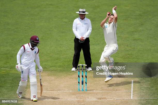 Matt Henry of New Zealand bowls while umpire Ian Gould of England and Shai Hope of the West Indies look on during day four of the Test match series...