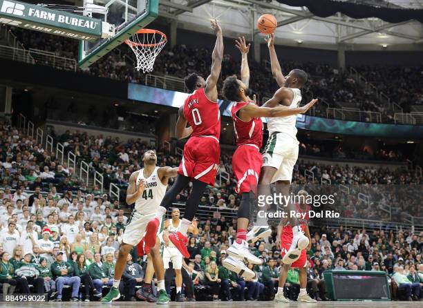 Jaren Jackson Jr. #2 of the Michigan State Spartans shoots overs Isaac Copeland of the Nebraska Cornhuskers at Breslin Center on December 3, 2017 in...