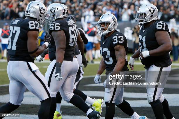 DeAndre Washington of the Oakland Raiders celebrates after scoring on a nine-yard run against the New York Giants during their NFL game at...