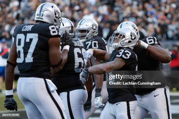 DeAndre Washington of the Oakland Raiders celebrates after scoring on a nine-yard run against the New York Giants during their NFL game at...