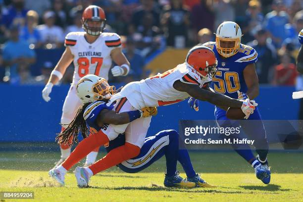 Tre Boston of the Los Angeles Chargers tackles Josh Gordon of the Cleveland Browns during the game at StubHub Center on December 3, 2017 in Carson,...