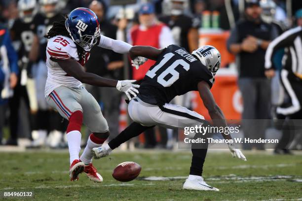 Johnny Holton of the Oakland Raiders fumbles the ball to the New York Giants during their NFL game at Oakland-Alameda County Coliseum on December 3,...