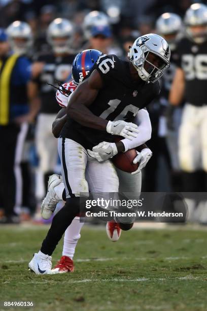 Johnny Holton of the Oakland Raiders fumbles the ball to the New York Giants during their NFL game at Oakland-Alameda County Coliseum on December 3,...