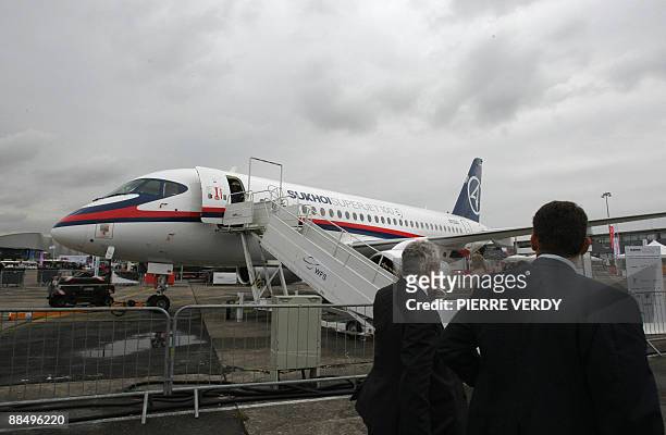 Visitors walk in front of the Russian Sukhoi Superjet 100 on June 15, 2009 during the week long 48th international Paris Air Show at Le Bourget...